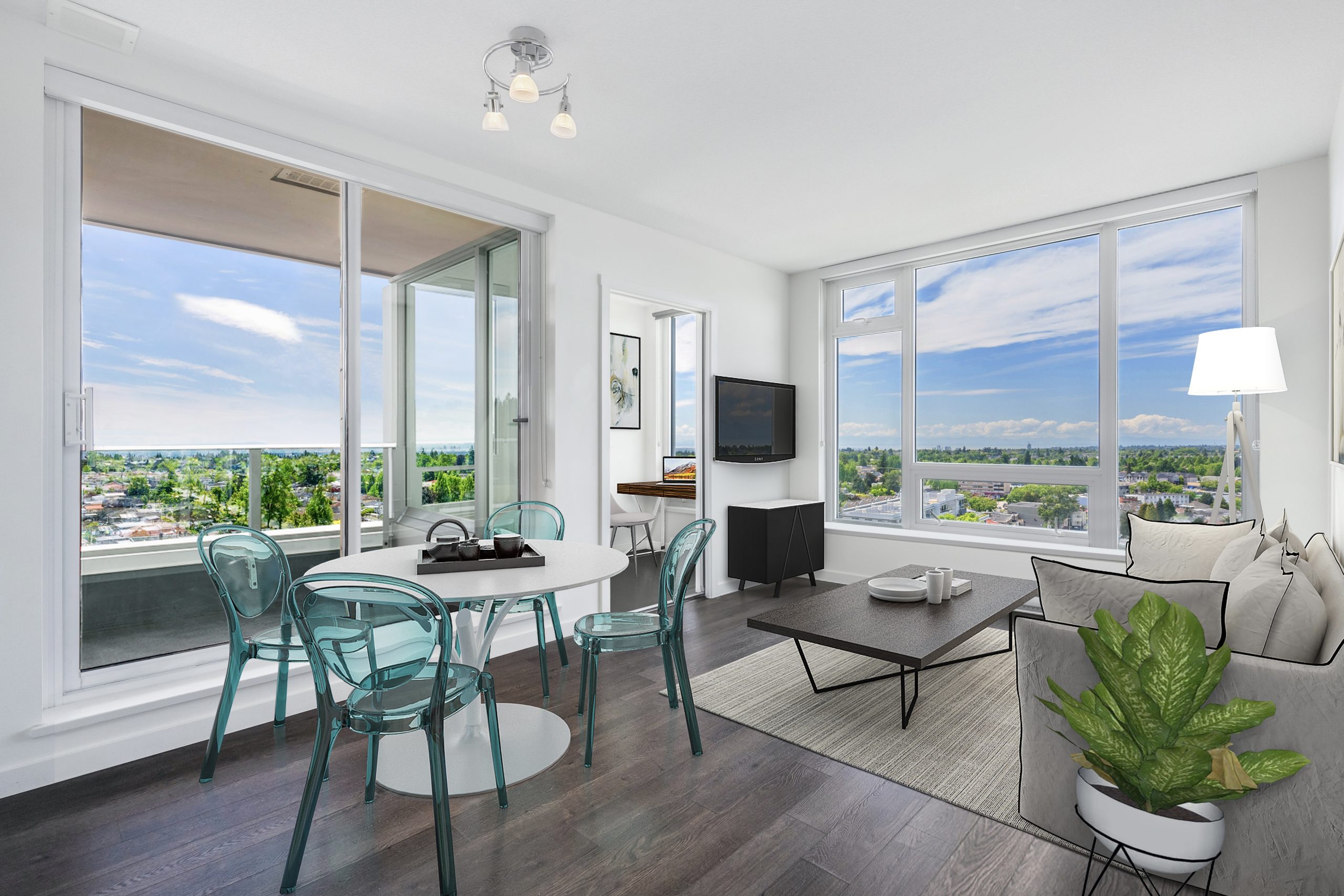 Light-filled living and dining room with floor-to-ceiling windows and a view across the water